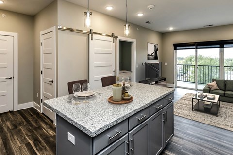 a kitchen with an island and a living room with a couch